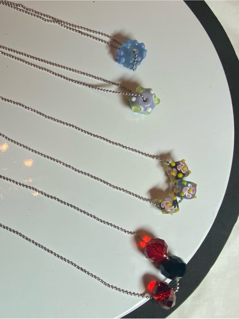 Set of 4 necklaces. Featuring lamp work beads and cut glass beads. Drop 13.5”.
